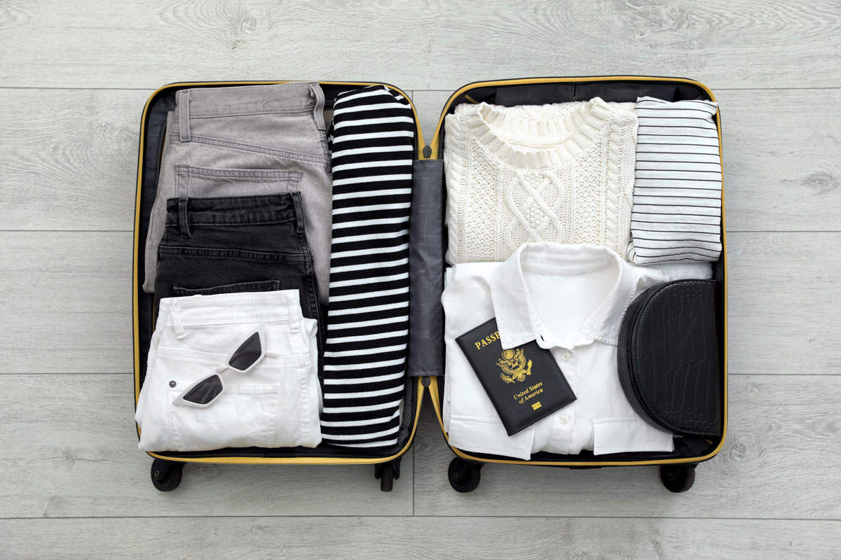 Open suitcase with clothes and belongings packed for a move abroad