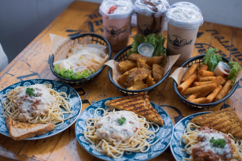 a wooden table topped with plates of food