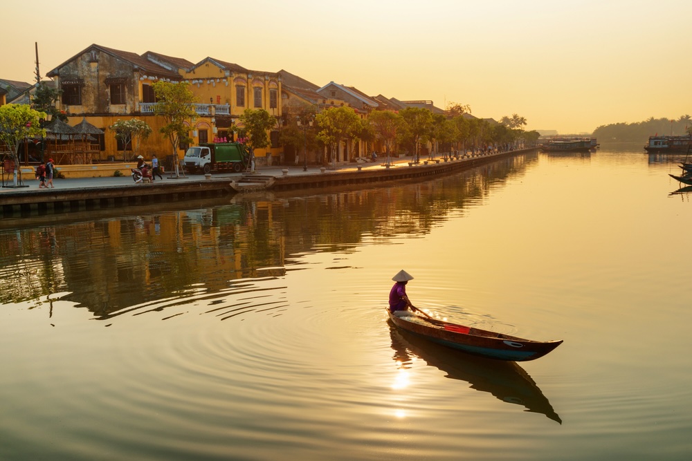 Gorgeous view of Vietnamese woman on boat at sunrise, Hoian
