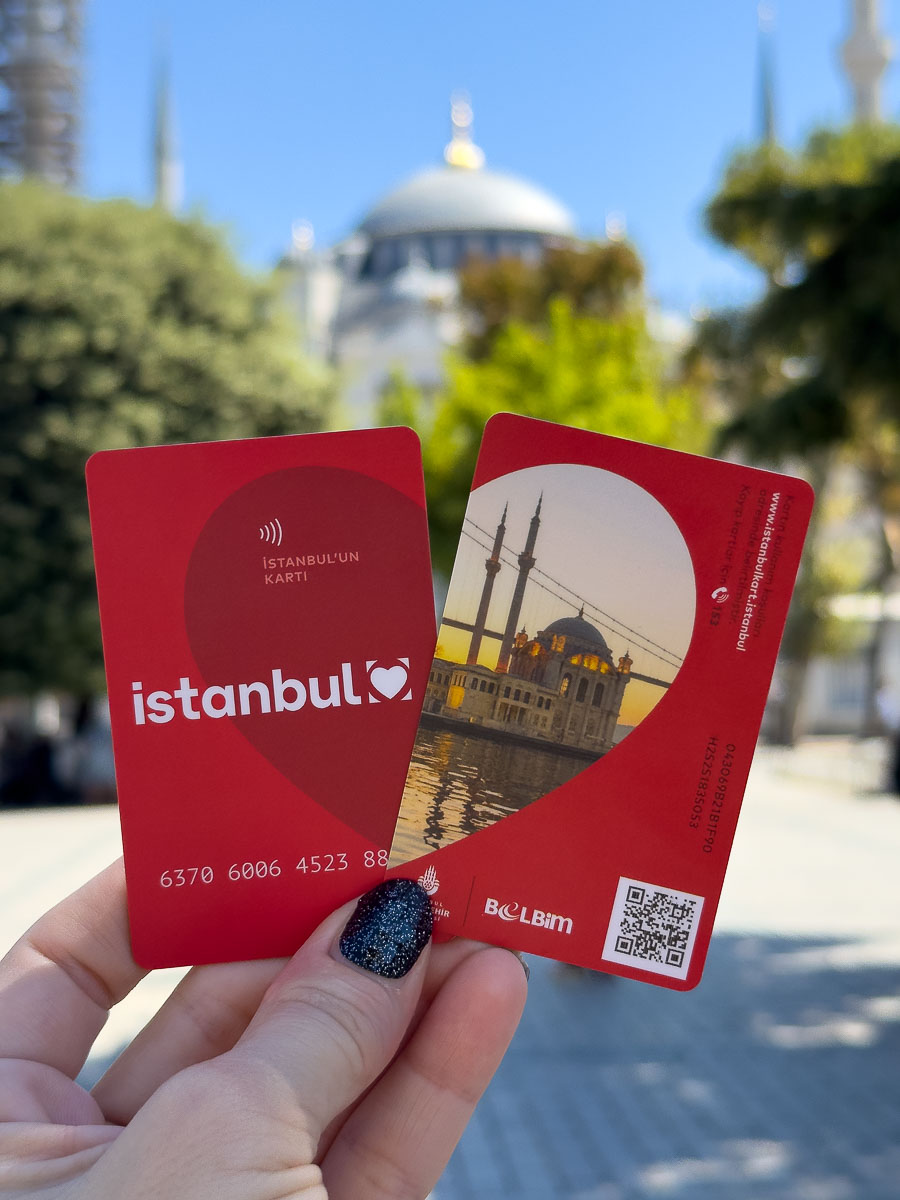 Nina holding two Istanbul red transit cards.