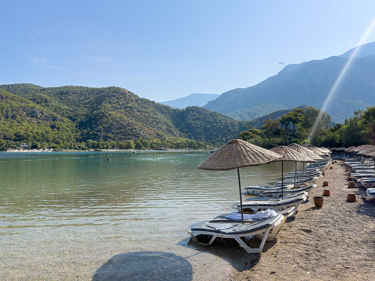 Blue Lagoon chairs on the shoreline.