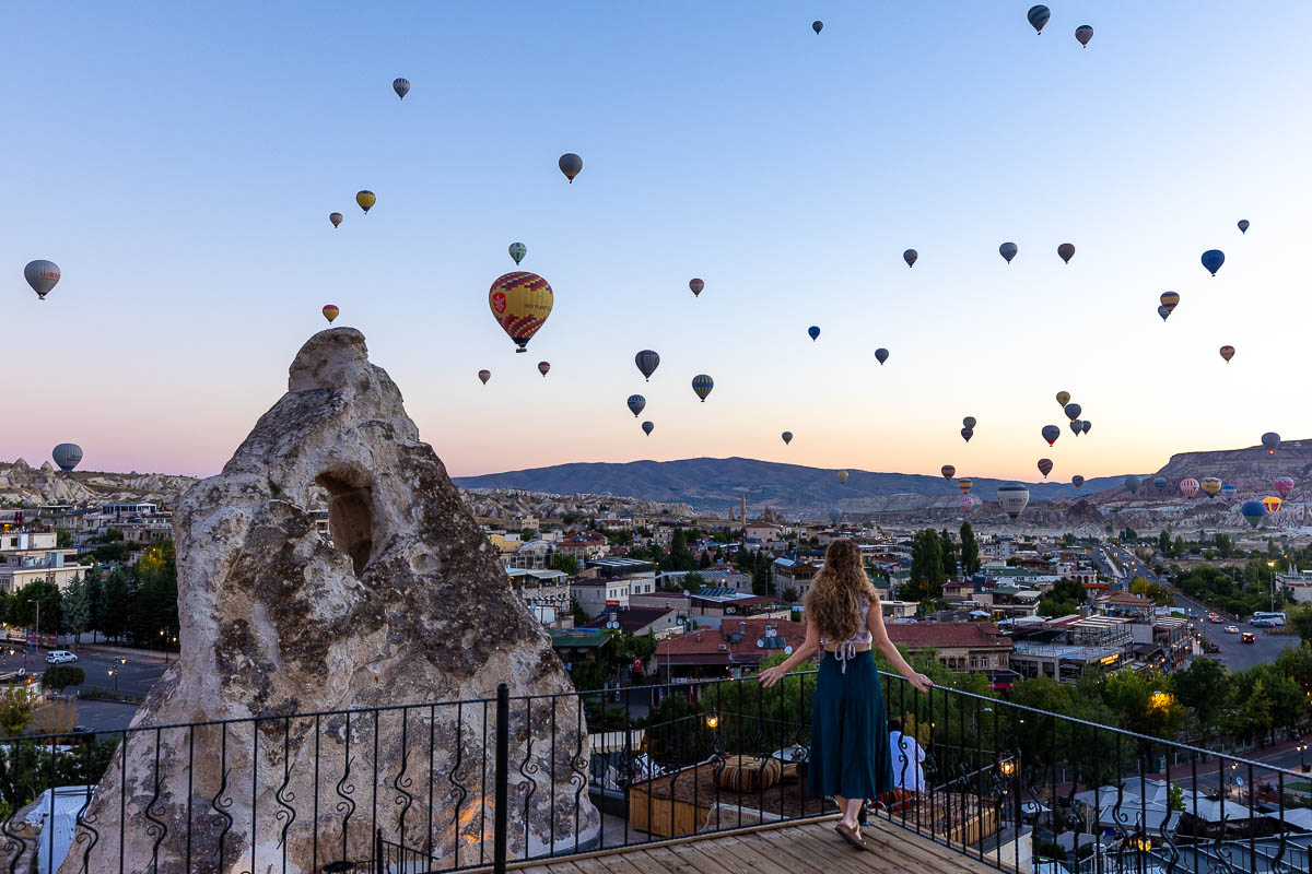Nina with hot air balloons floating everywhere on her Cappadocia itinerary.