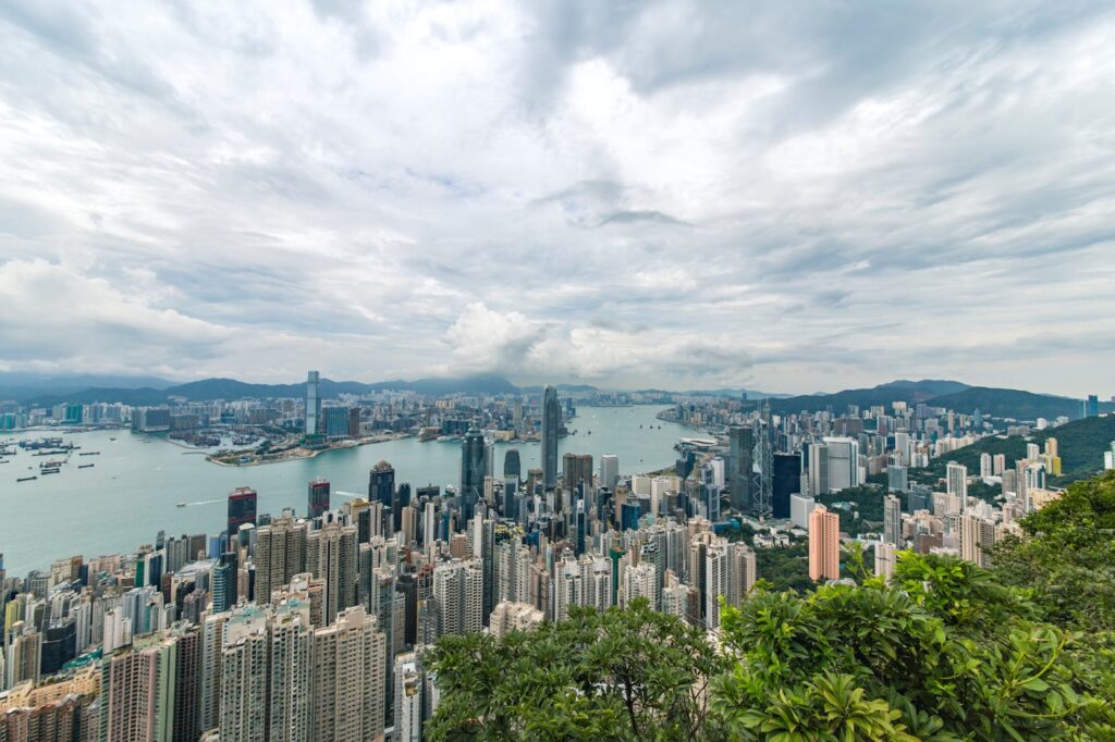 A breathtaking aerial panorama of Hong Kong's iconic skyline with towering skyscrapers and Victoria Harbour.
