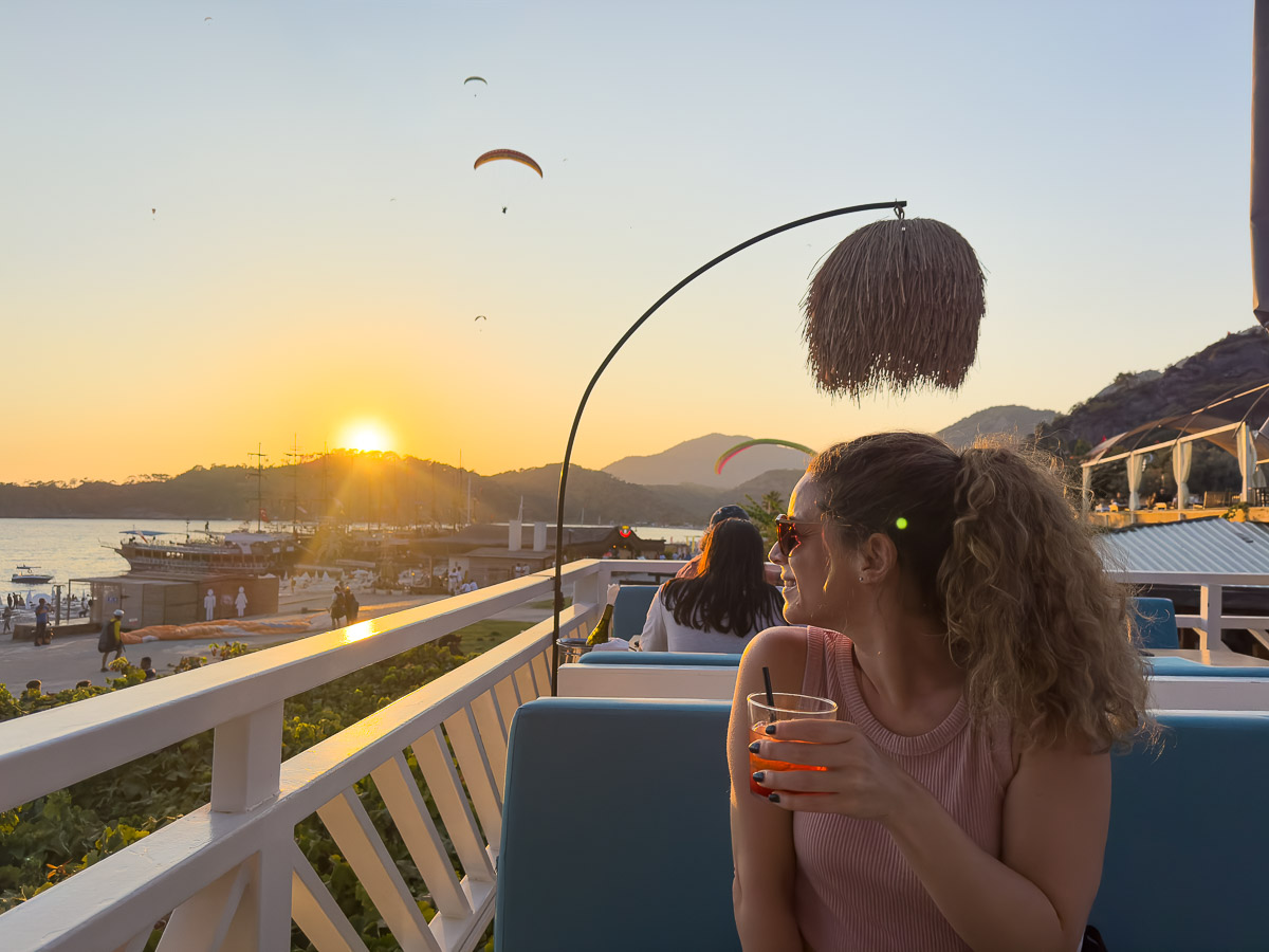 Nina at Buzz Beach Bar with paragliders overhead in Oludeniz.