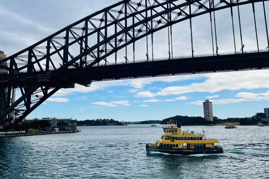 The ferry from Circular Quay to Manly gliding under the Harbour Bridge