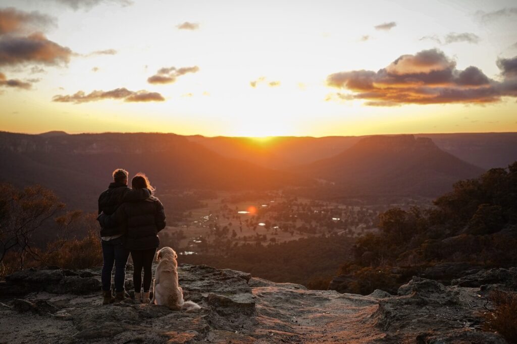 A couple of people standing on top of a mountain