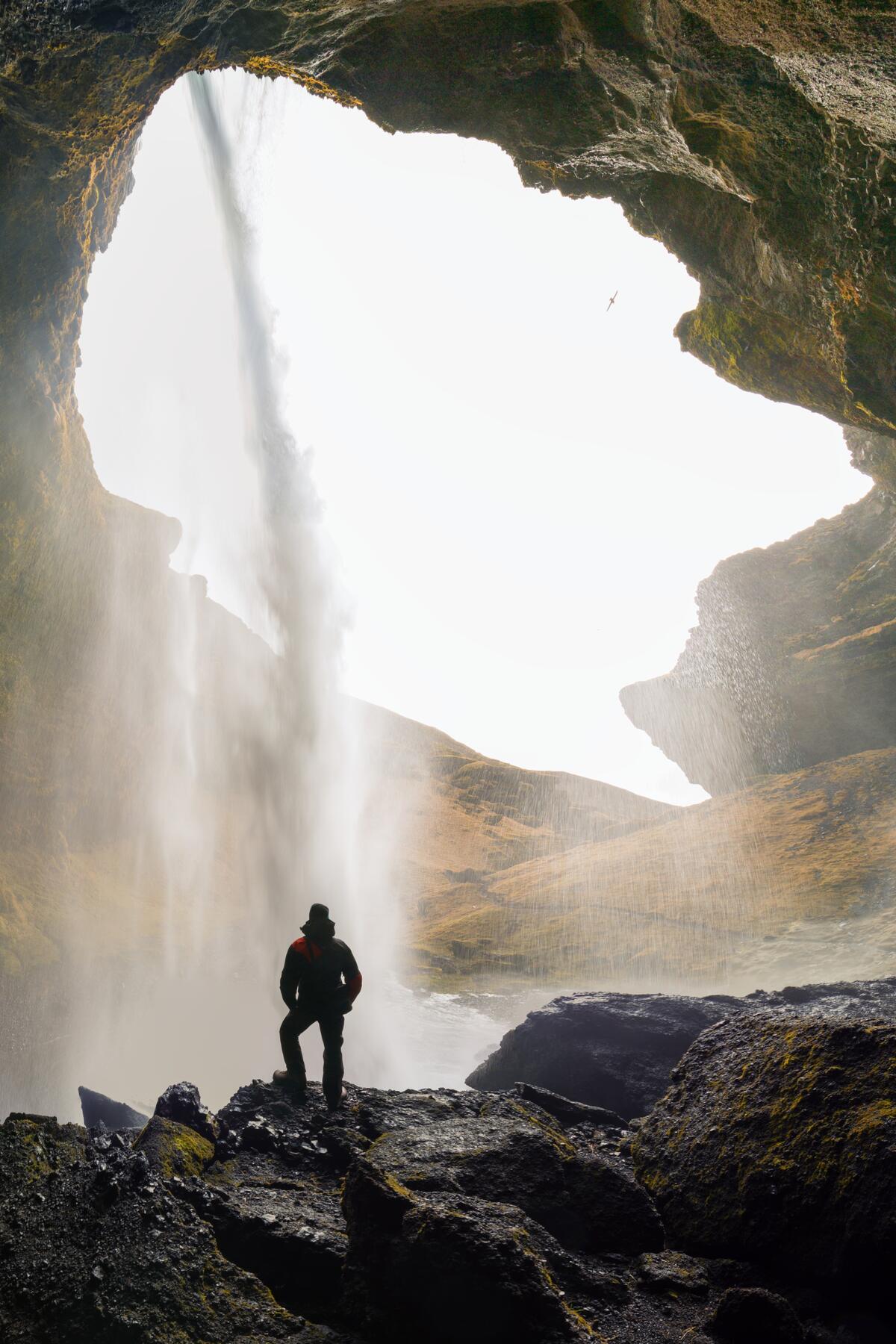 Person standing behind Kvernufoss.