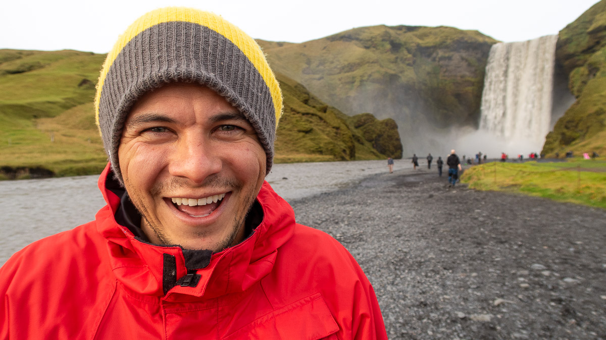 Garrett smiling at Skógafoss.