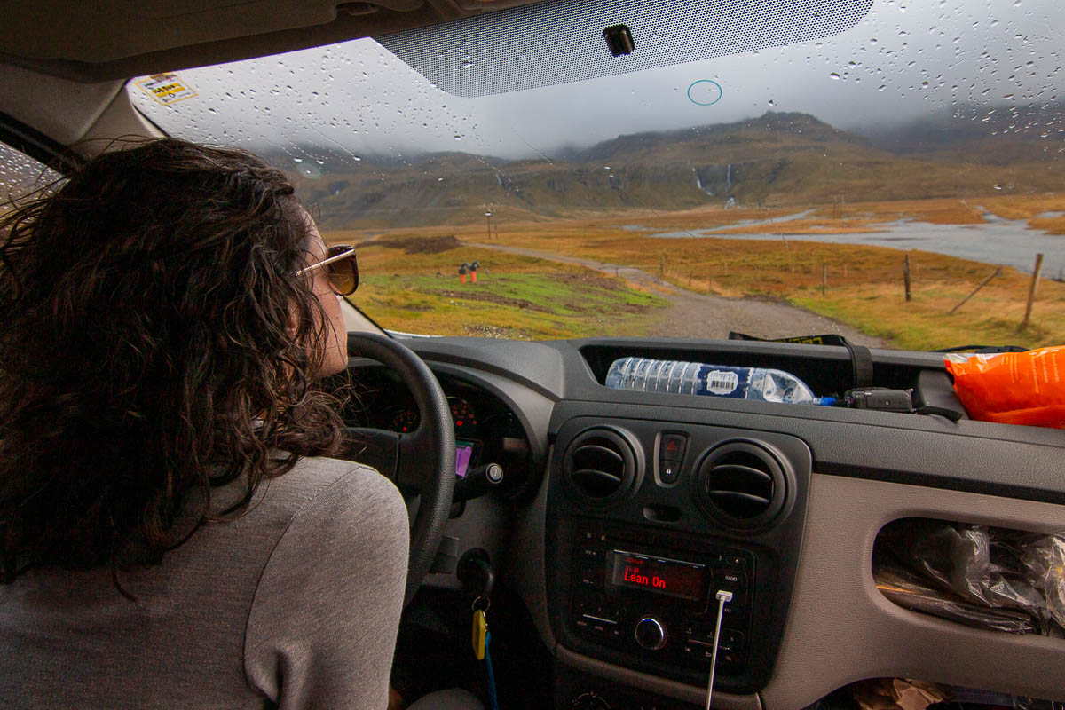 Snaefellsnes Peninsula nina in driver seat gravel road.