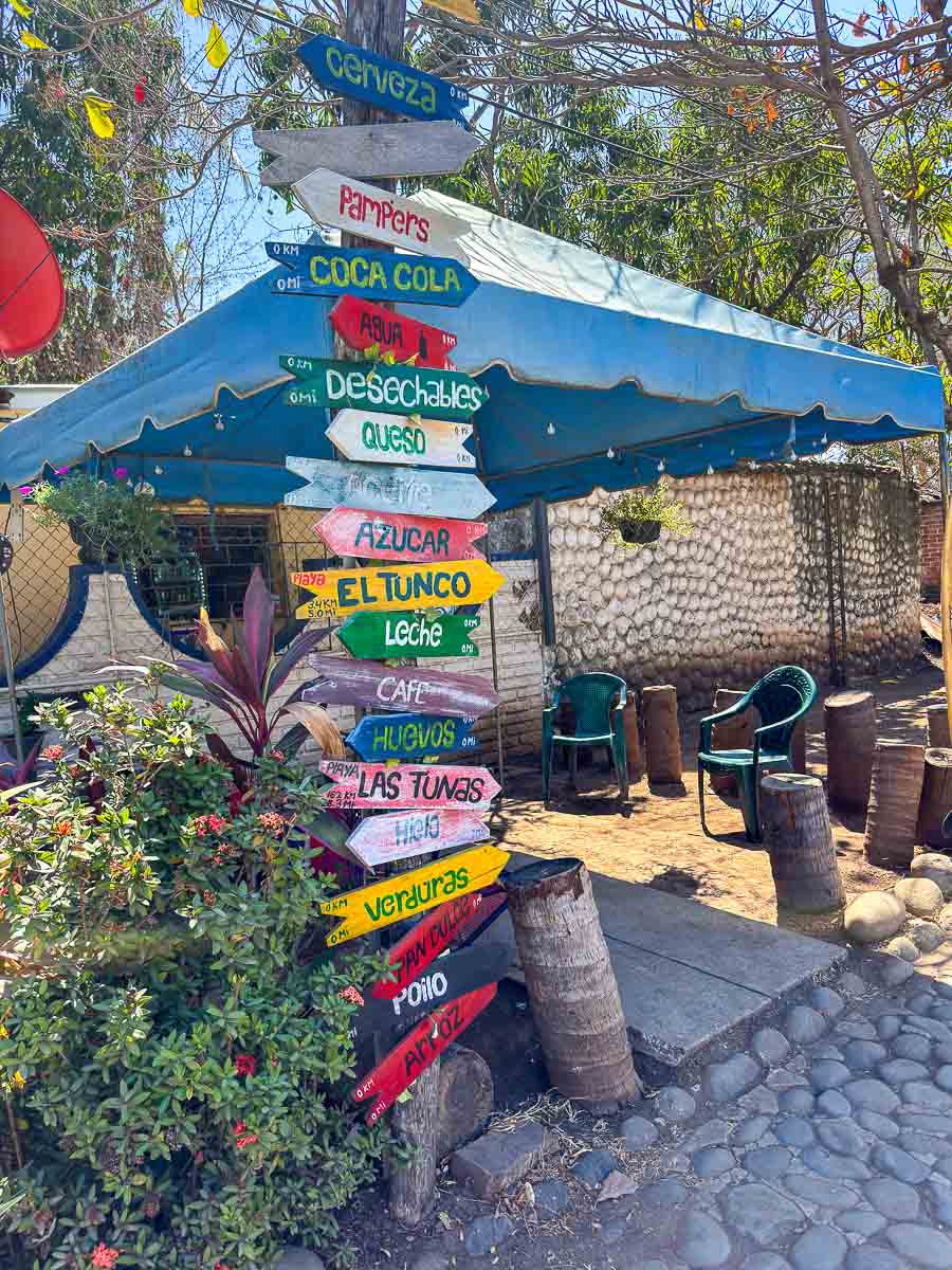 Colorful sign with directions to nearby spots in El Salvador.