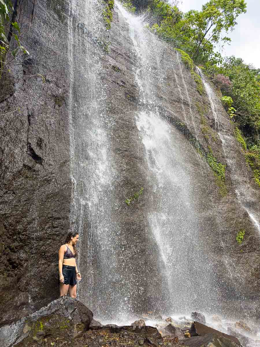 Nina under a waterfall.