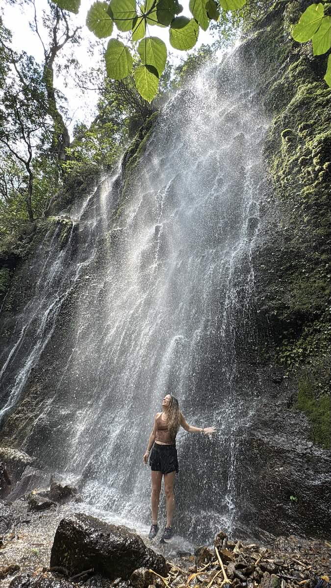 nina under falls on 7 waterfalls hike.