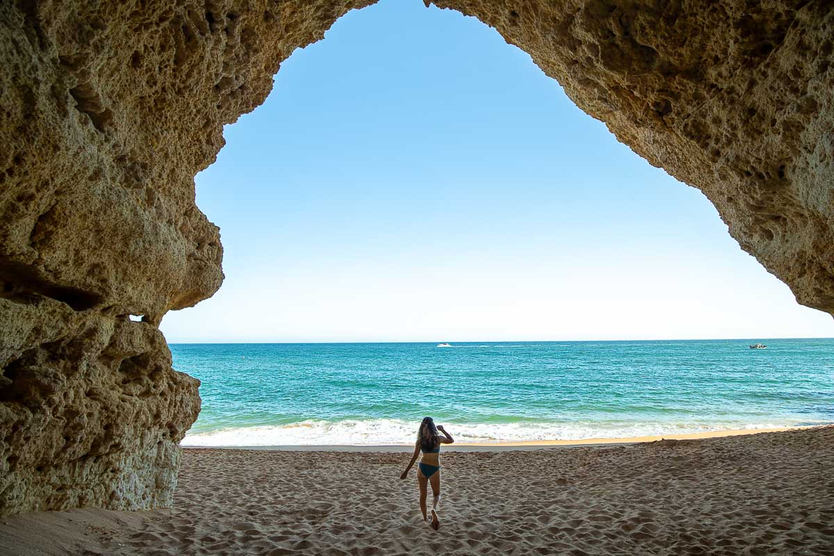 Nina running to the ocean from a cave in the Algarve.