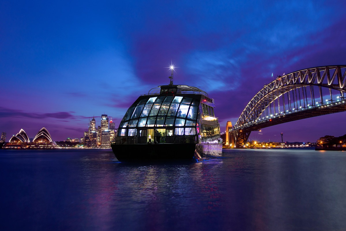 Dinner cruise on Sydney Harbour at night with city lights and harbour views.