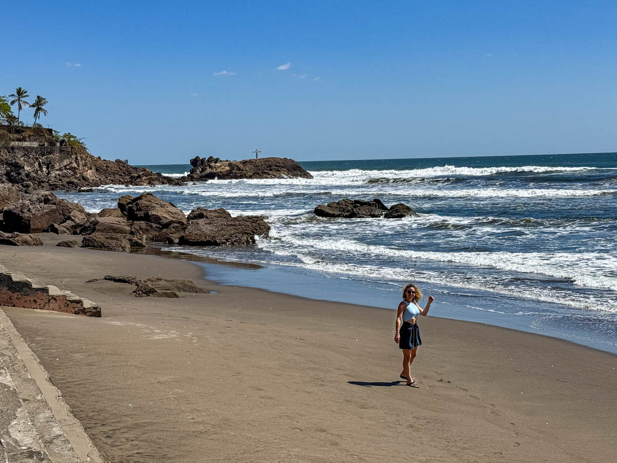 Nina on the dark-sand beach at Las Peñitas, Nicaragua
