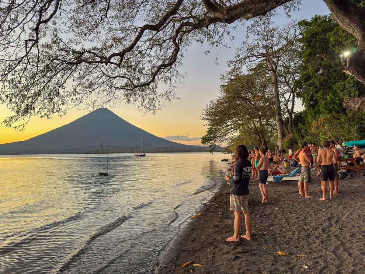 Sunset crowds on the sand at Playa Mangos, Ometepe