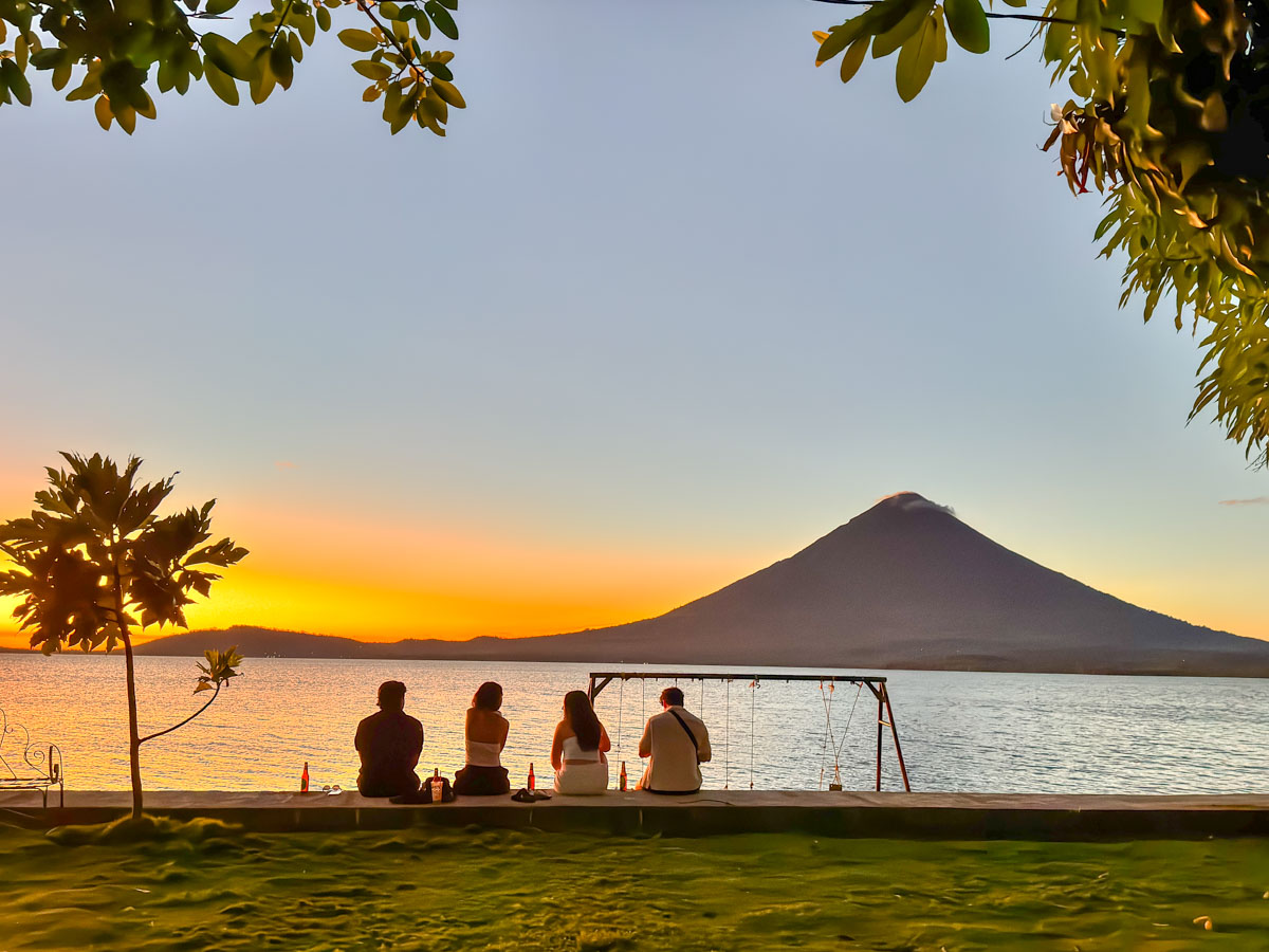 Friends watching sunset over Lake Nicaragua at Playa El Perú, Ometepe