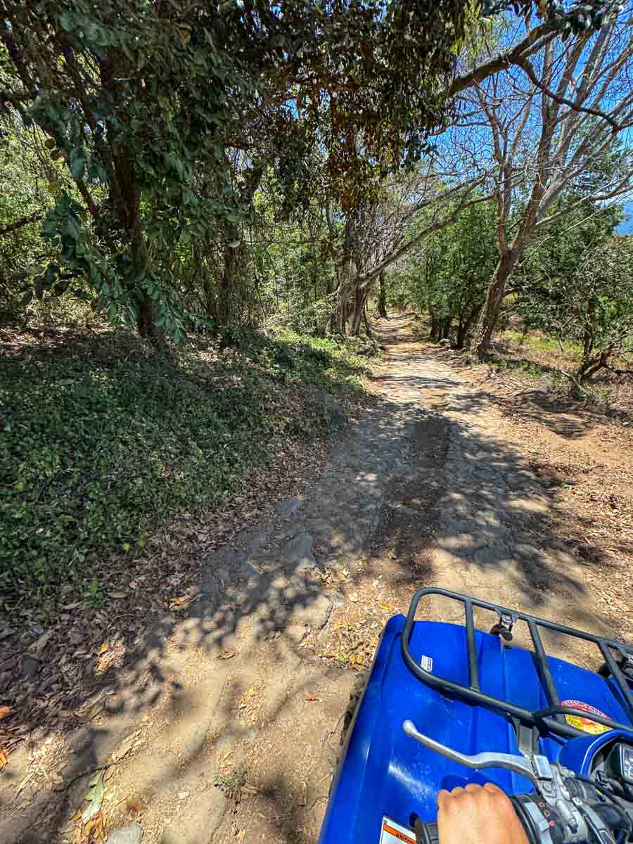 Riding an ATV up the rough access road to San Ramón waterfall