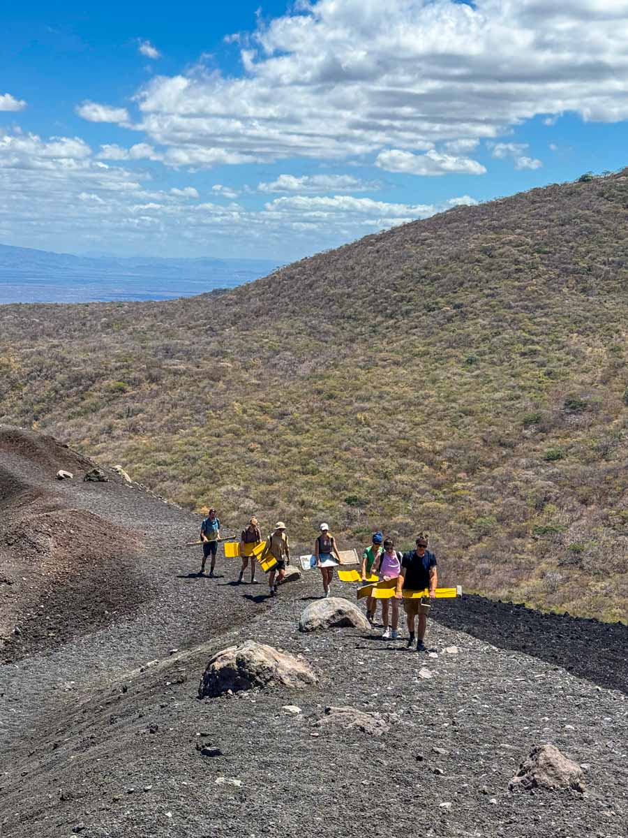 People hiking up Cerro Negro volcano near León, Nicaragua
