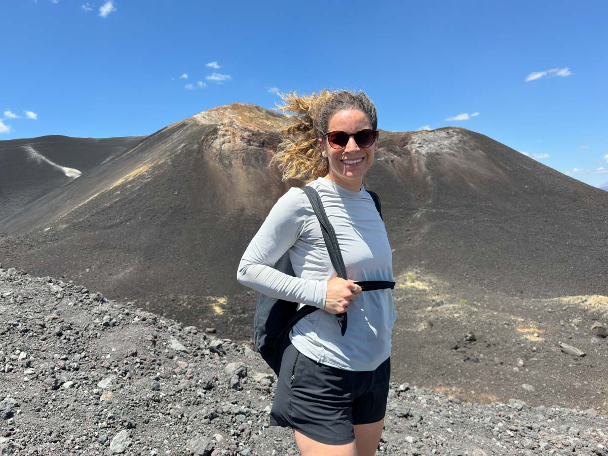 Nina on top of Cerro Negro on a windy day before volcano boarding