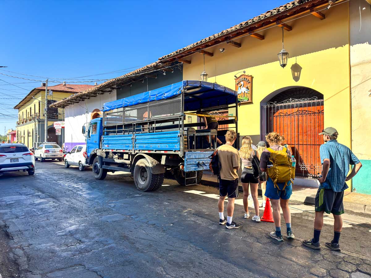 Open-air truck loading up for the volcano boarding tour from León