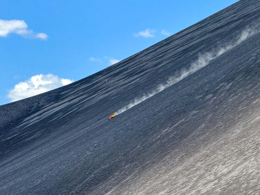 Cerro Negro Volcano tiny person boarding down.