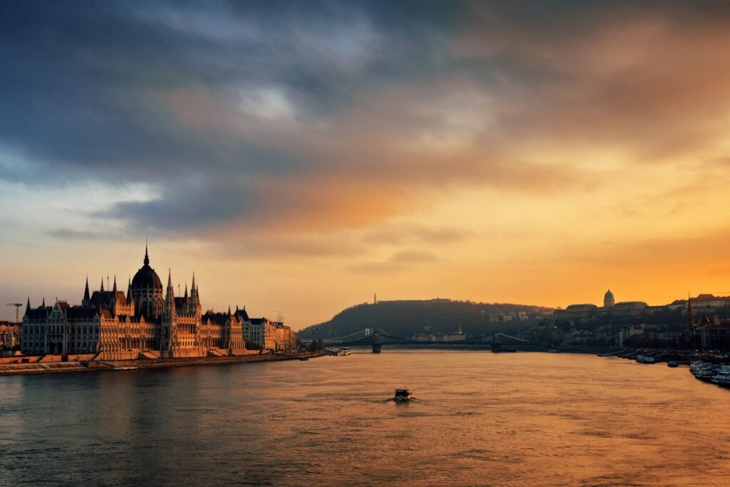 a large building sitting on the side of a river