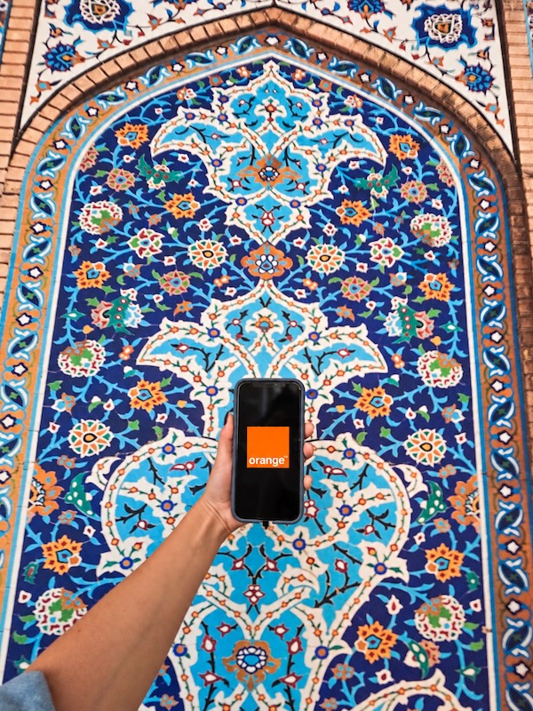 orange esim with mosaic background.