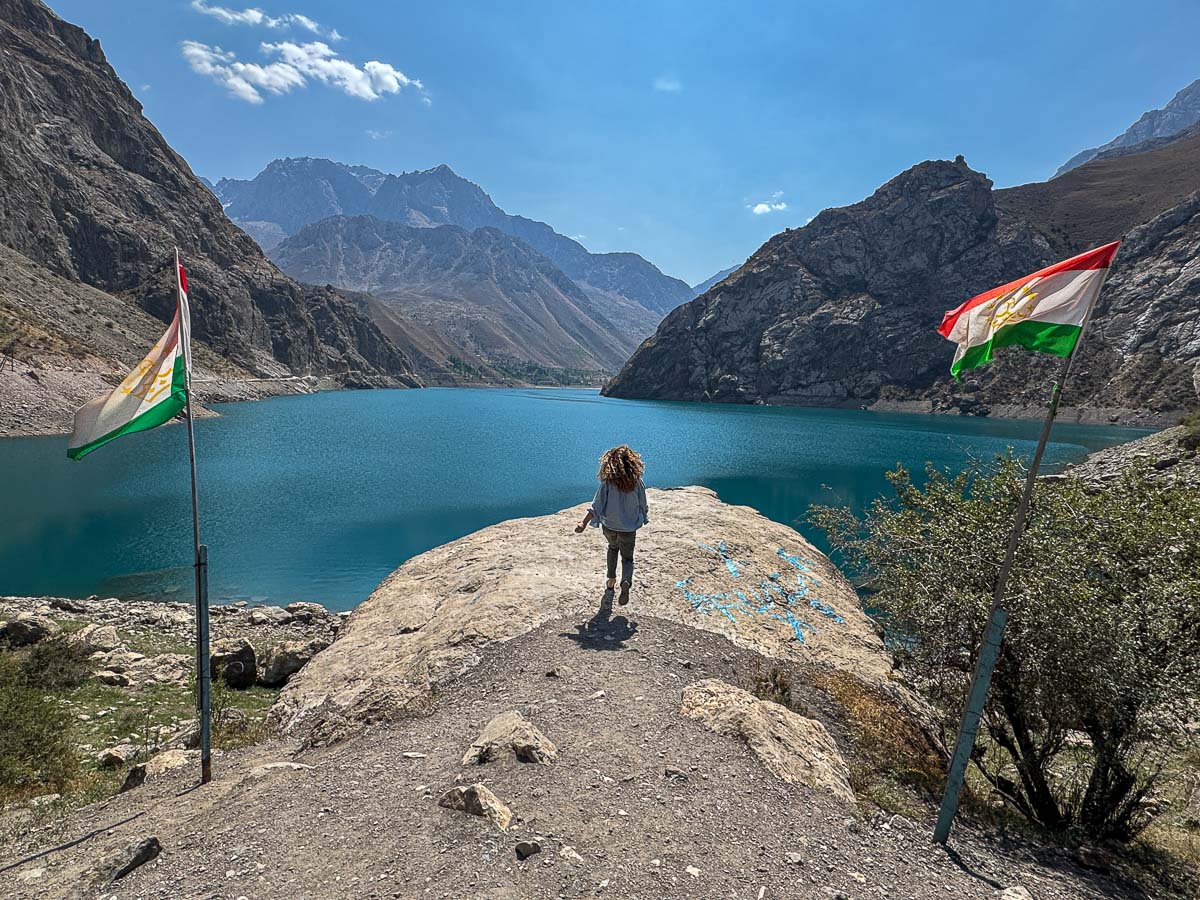 Nina walking on a rock beside one of the Seven Lakes in the Fann Mountains, Tajikistan