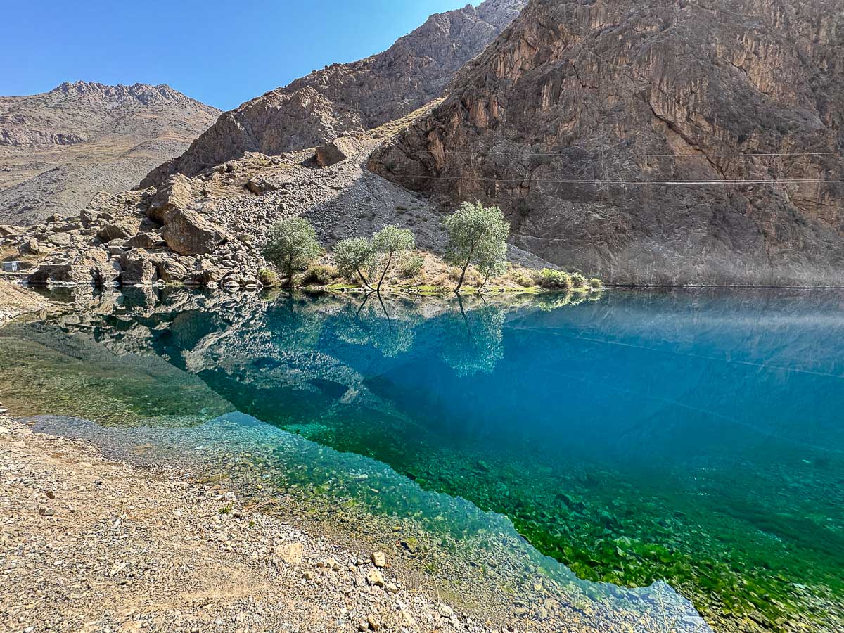 Mountain reflection on one of the turquoise Seven Lakes in the Fann Mountains, Tajikistan