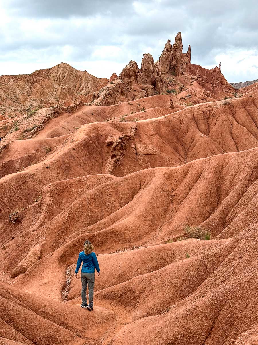 Nina hiking through the colorful rock formations of Fairytale (Skazka) Canyon, Kyrgyzstan
