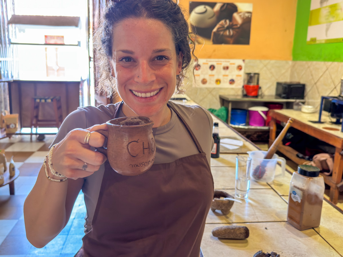 Nina drinking the cacao drink she made at ChocoMuseo Granada
