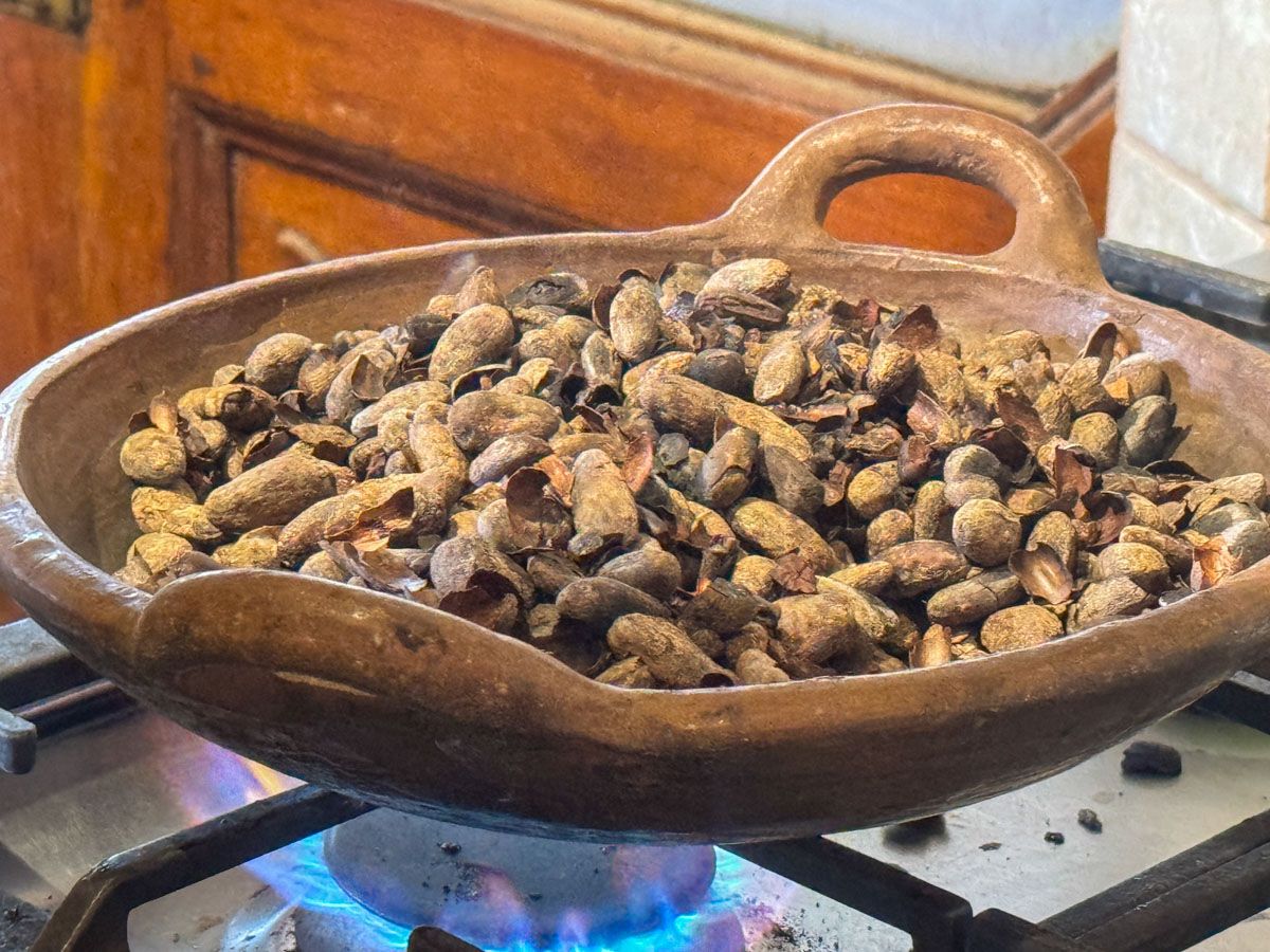 Roasting cacao beans during the ChocoMuseo chocolate workshop in Granada