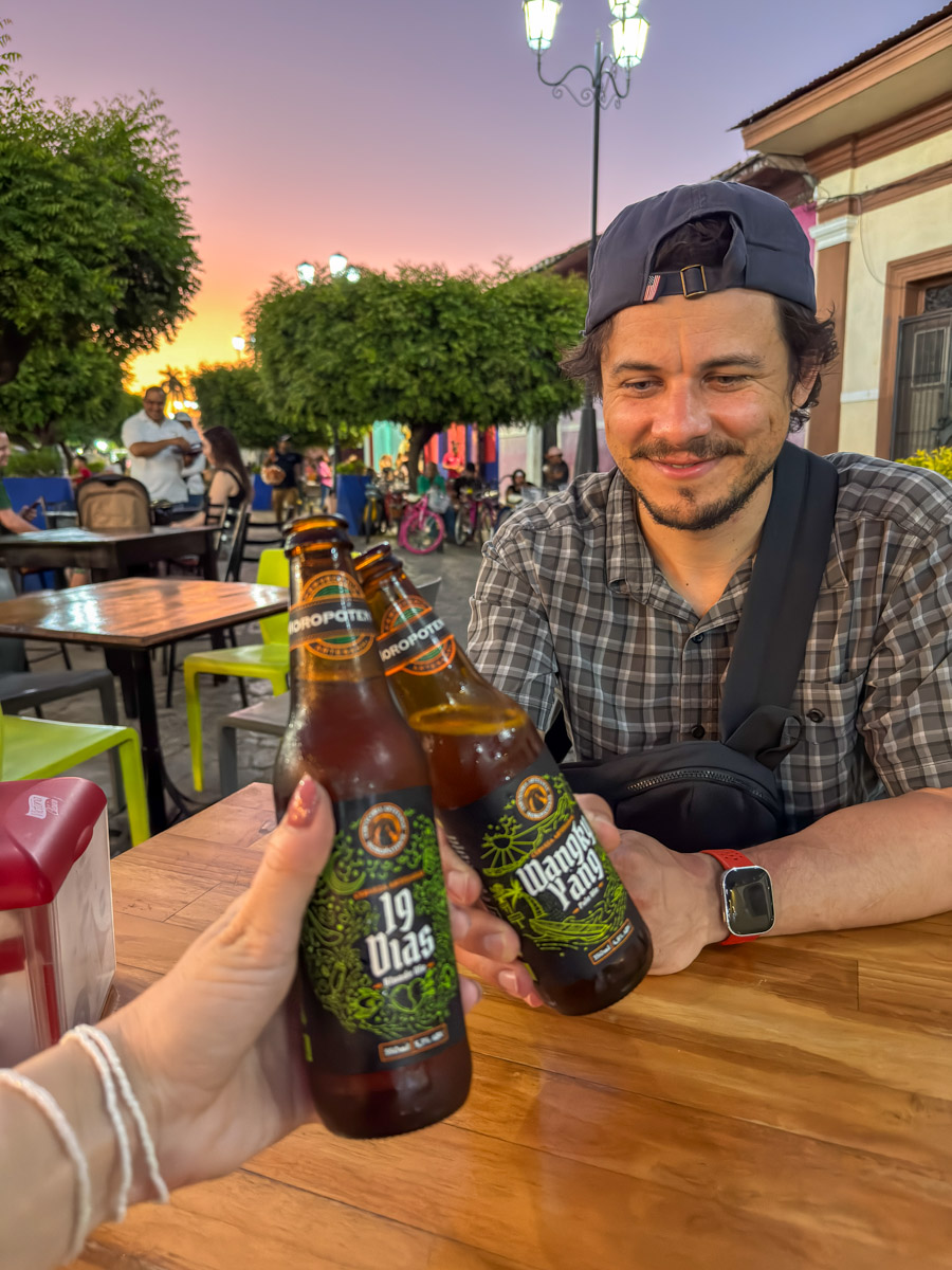 Garrett and Nina cheersing local craft beers in Granada