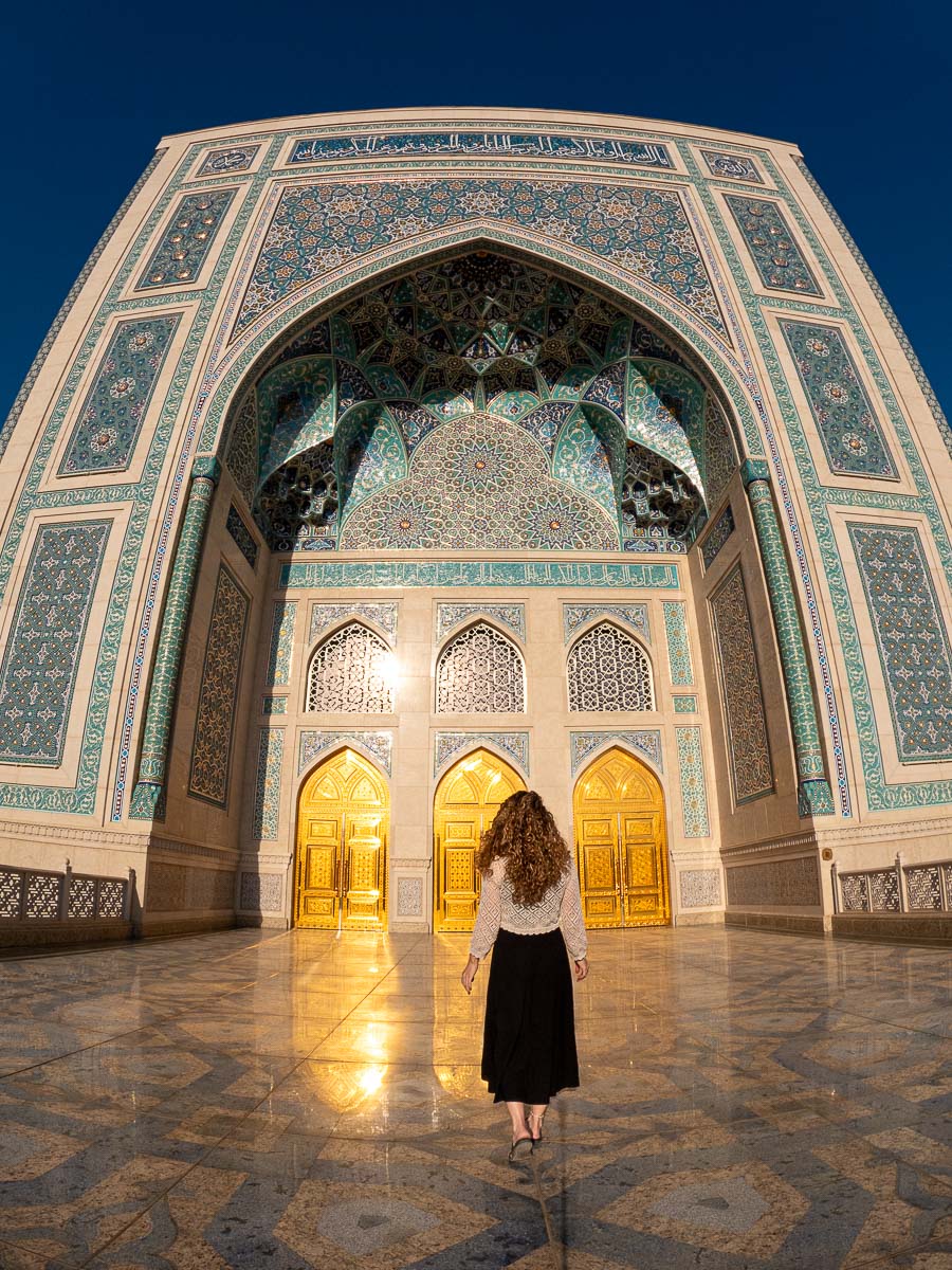 Nina walking toward the tiled archway at the Hazrati Imam Complex in Tashkent, Uzbekistan