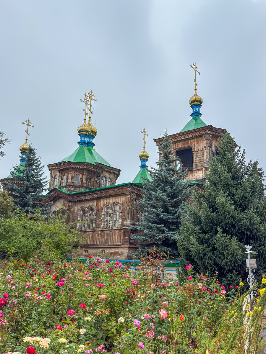 Wooden Holy Trinity Cathedral with green domes in Karakol, Kyrgyzstan