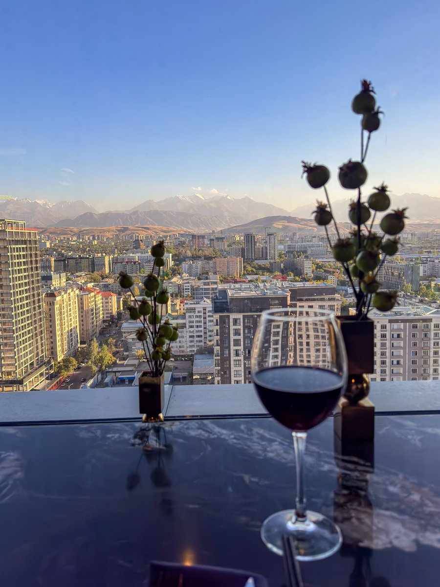 Glass of red wine at IWA Sky Bar overlooking Bishkek and the mountains, Kyrgyzstan