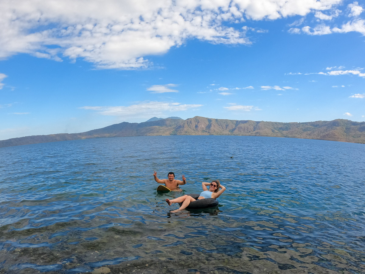 Nina and Garrett floating in the clear water of Laguna de Apoyo, Nicaragua