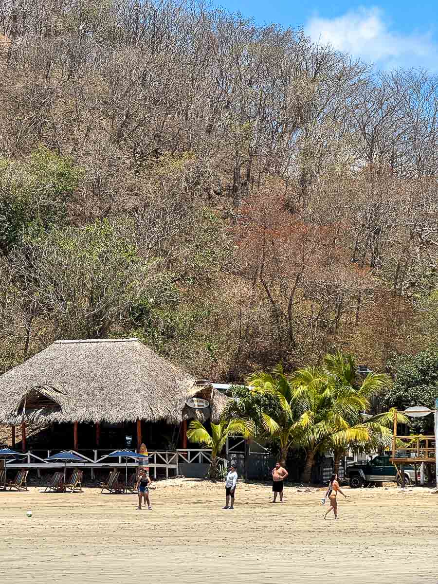 Beach hut and people hanging out at Playa Maderas, Nicaragua