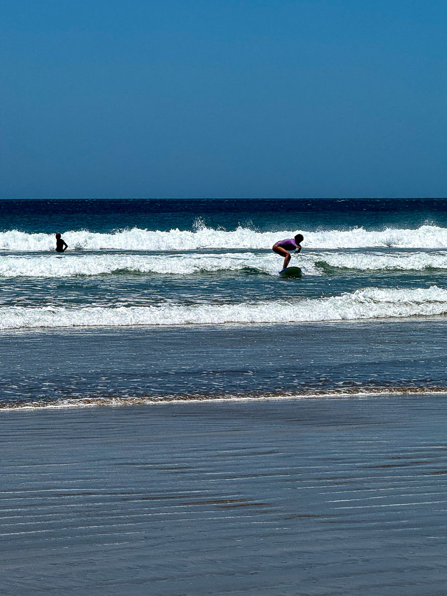 Surfer heading out at Playa Maderas near San Juan del Sur