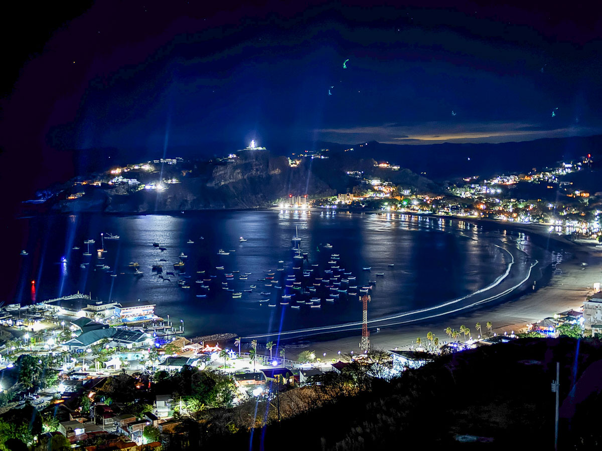 View over San Juan del Sur bay at night from a hillside stay above town