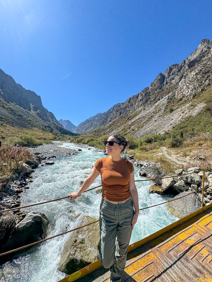 Nina on a bridge over a mountain river at Ala Archa National Park, Kyrgyzstan