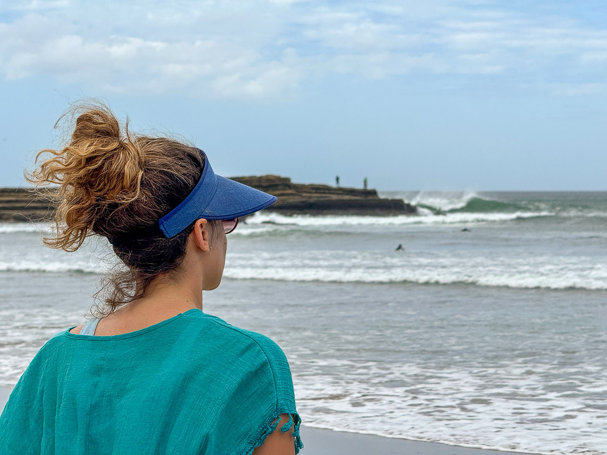 Nina watching a surfer from the beach in Popoyo, Nicaragua