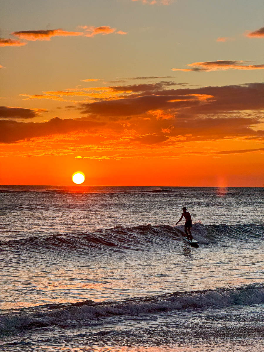 Surfer silhouetted against a Popoyo sunset, Nicaragua
