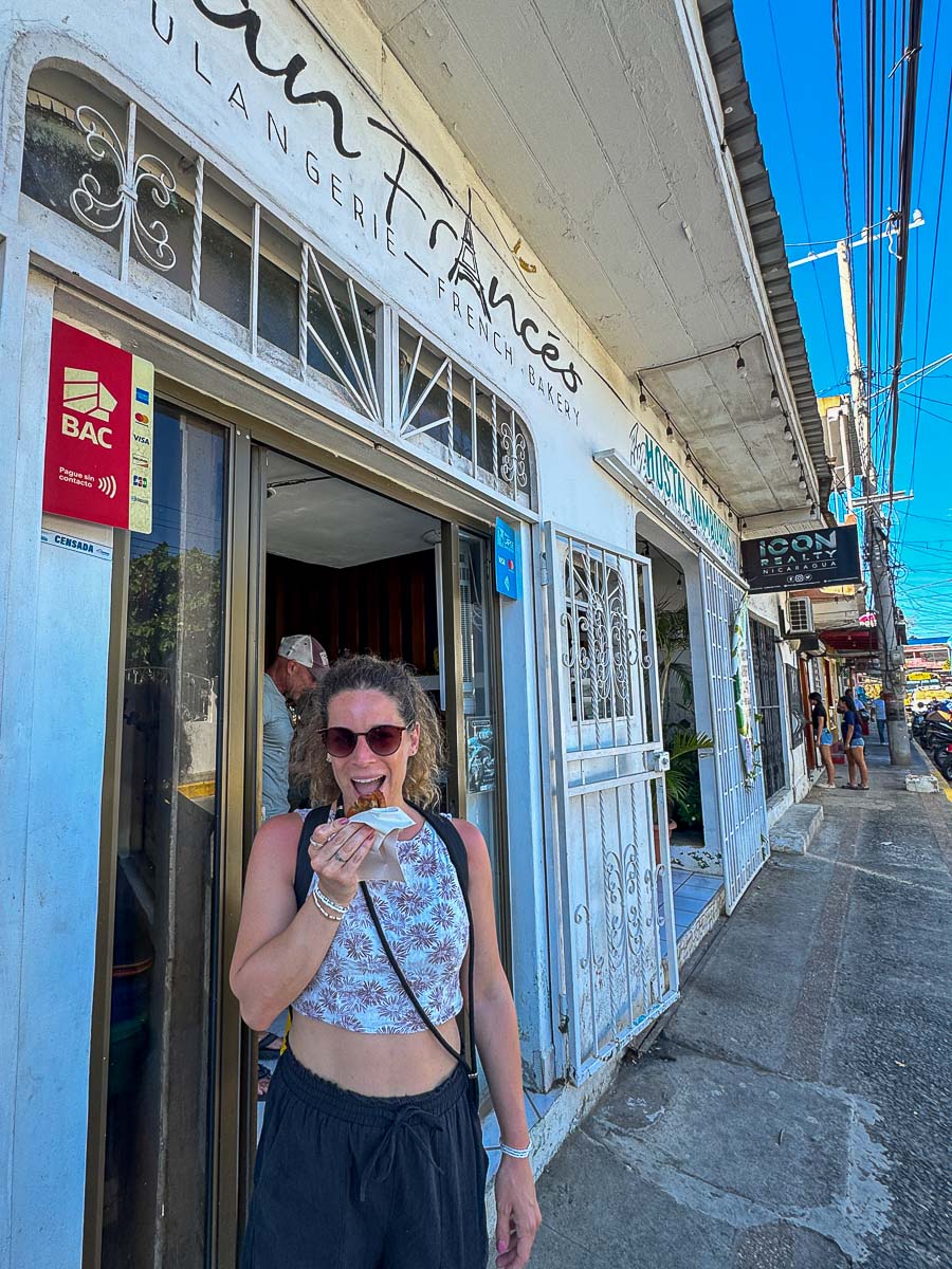 Nina eating fresh bread outside a bakery in San Juan del Sur