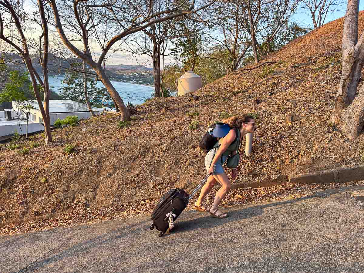 Nina lugging her suitcase up the hill to a stay above San Juan del Sur