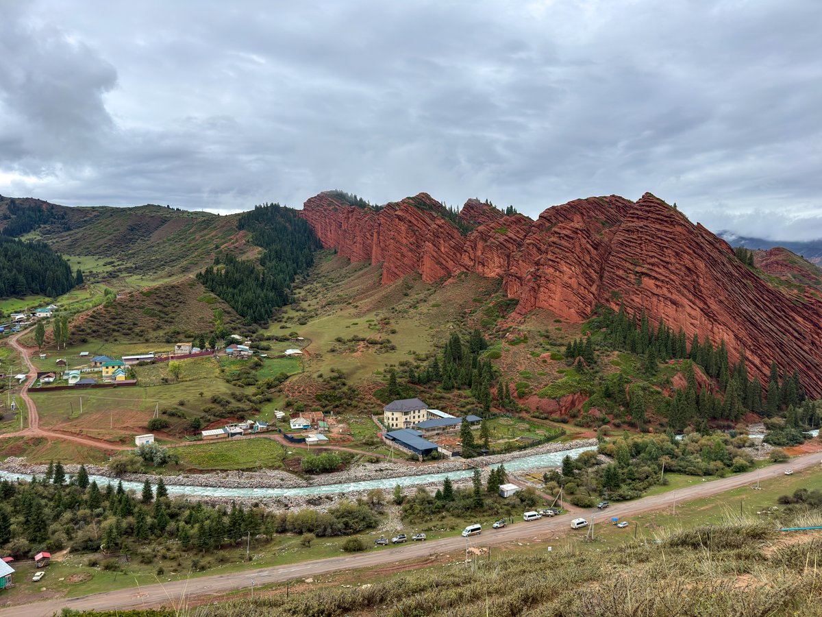 Red Seven Bulls rock cliffs above a village in the Jeti-Oguz gorge, Kyrgyzstan
