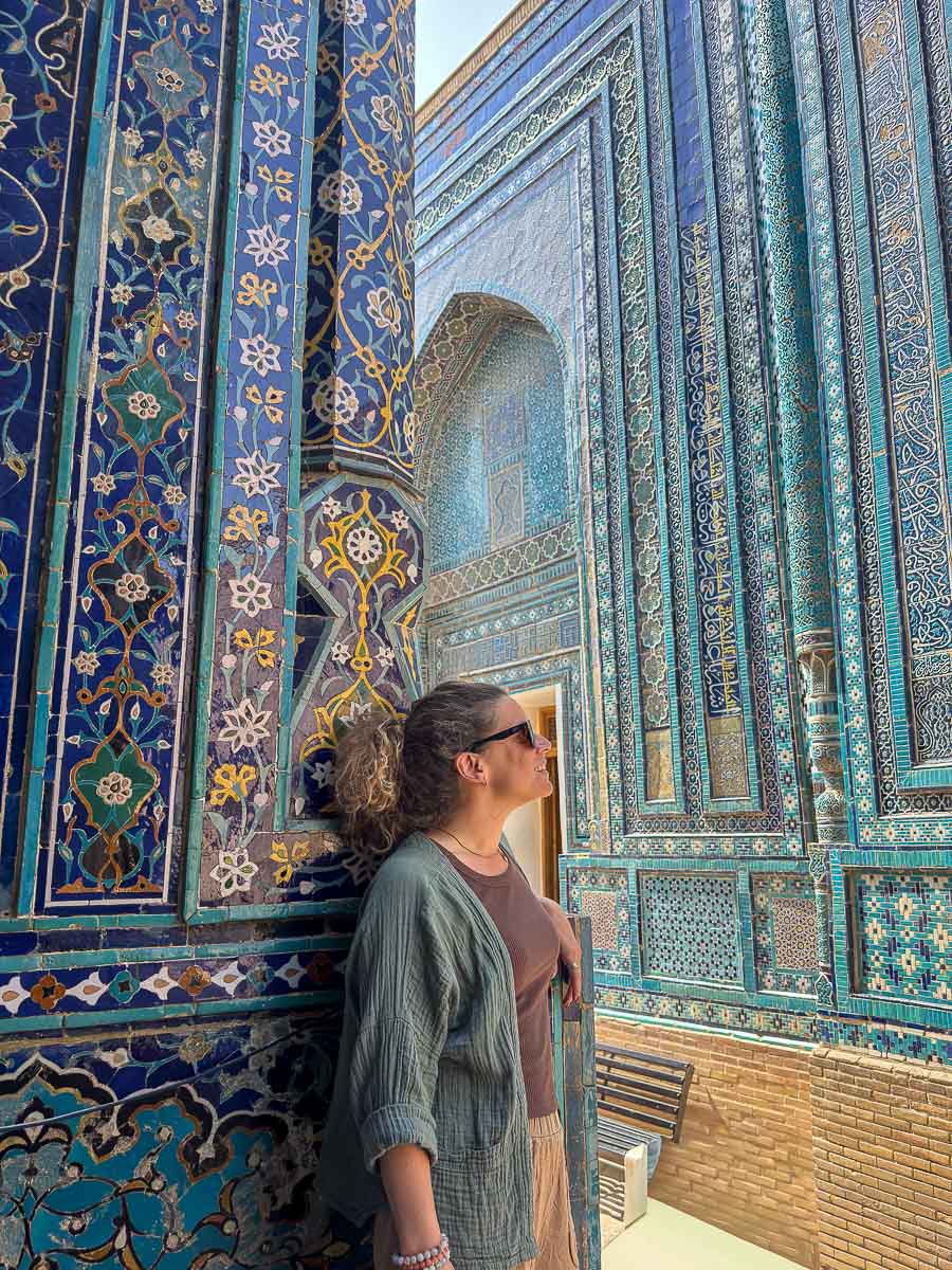 Nina posing outside the blue tiled tombs of Shah-i-Zinda in Samarkand, Uzbekistan