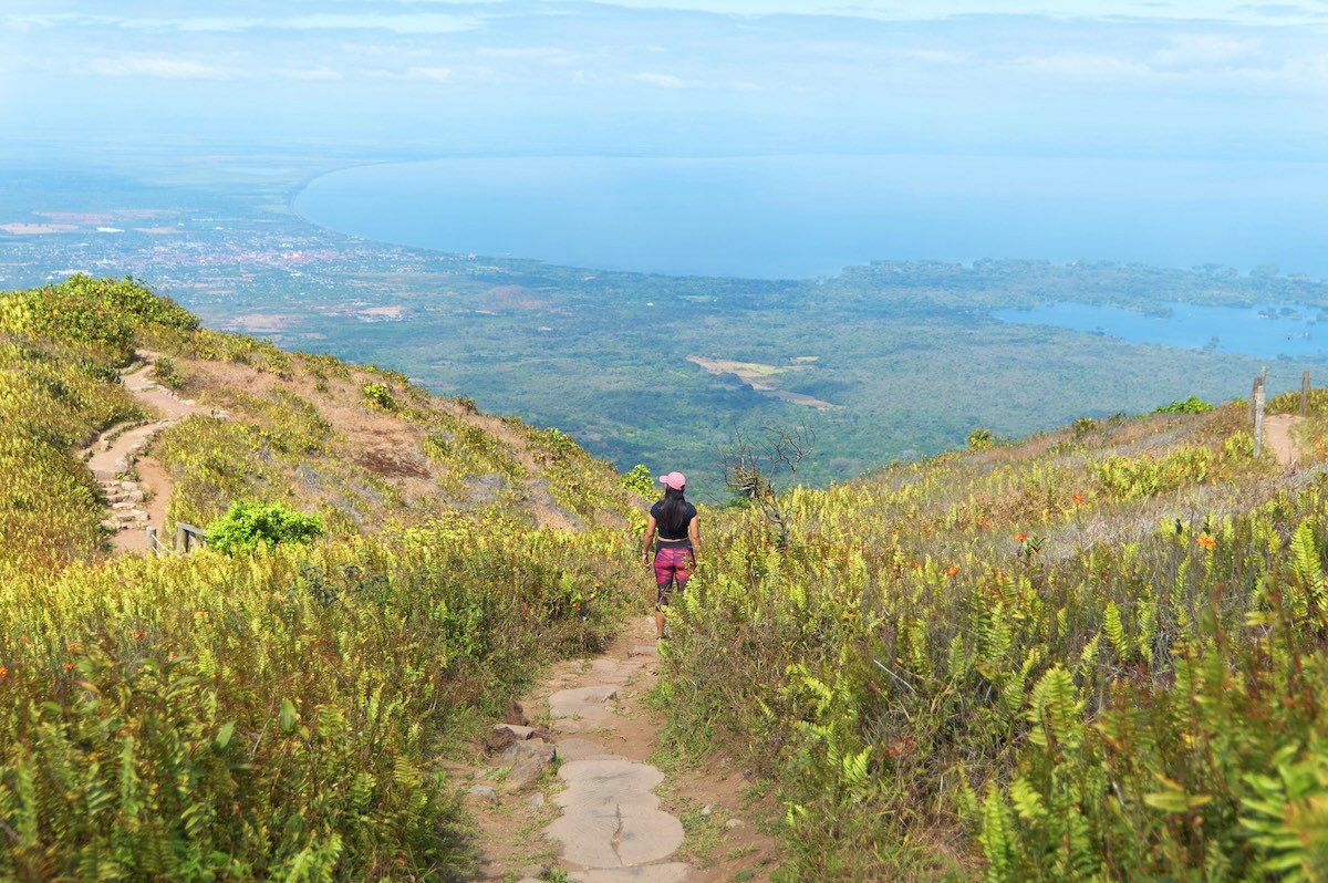 Woman on the Mombacho Volcano trail looking out over the view near Granada